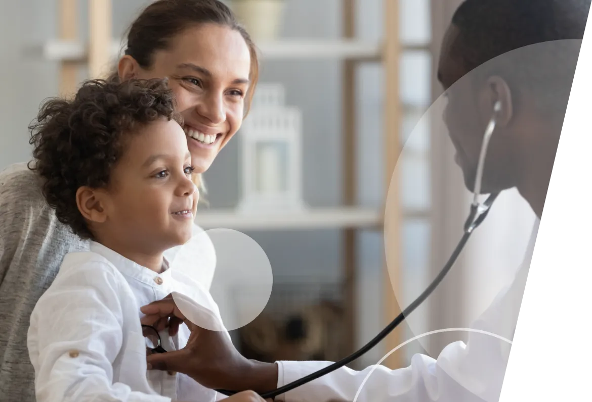 Medical professional using stethoscope on child